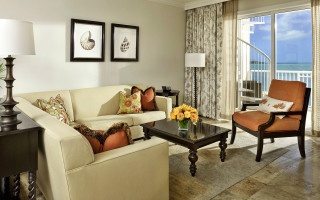 Livingroom oceanview balcony couch chair - a living room free wallpaper