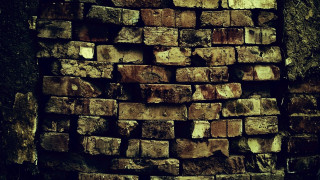 Bricks pile wall building night - a sidewalk in front free wallpaper