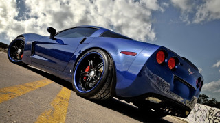 Blue sports car cloudy sky 12 - the side of a road free wallpaper