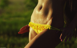 Woman yellow bikini frilly posing - her waist free wallpaper