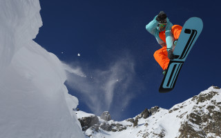 Snowboarder orange pants trick mountain - 8k photorealistic free wallpaper