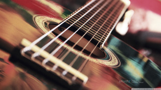 Guitar neck strings blurry background - a close up of a guitar neck free wallpaper