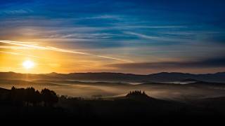 Sunset mountain range clouds trees 2 - a sunset over a mountain range free wallpaper for desktop