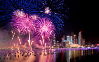 Fireworks cityscape reflection night sky - free new year wallpaper for desktop