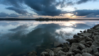 Large water shore clouds trees - a large body of water free wallpaper
