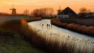 Skating group river sunset windmills - free landscape wallpaper