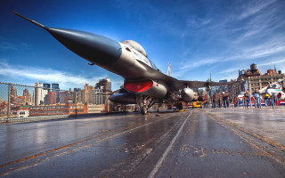 Jet fighter wet runway cityscape - a jet fighter plane free wallpaper