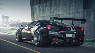 Black sports car driving building - the side of it free wallpaper