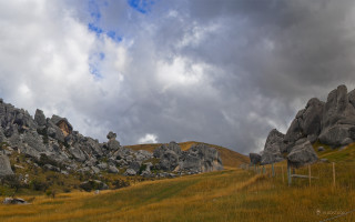 Grassy field rocks fence cloudy - rock free wallpaper