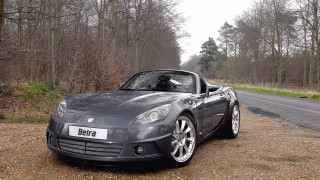 Grey sports car forest road - a grey sports car free wallpaper