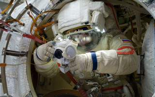 Space suit man holding device - free space wallpaper