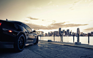Black car city water beach - the side of a road near a body of water free wallpaper