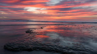 Sunset ocean rock wave beach - a sunset over the ocean free wallpaper