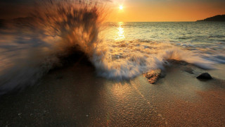 Wave sunset beach fireworks reflection - the sun in the distance free wallpaper