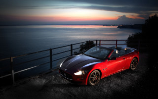 Red sports car ocean night - free sunset wallpaper