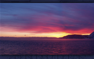 Sunset mountains water sky clouds - a sunset over a body of water free wallpaper