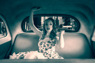 Woman waving in car fashion - the back of a car free wallpaper