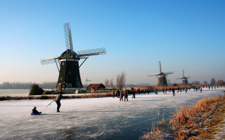 Skating group winter lake windmills - the ice free wallpaper
