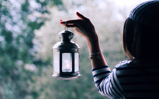 Woman holding lantern outside window - a lantern free wallpaper for desktop