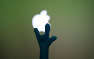 Hand holding apple logo green - a hand free wallpaper