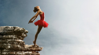 Woman red dress arabesque rock - her leg bent free wallpaper