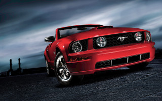 Red mustang night parking lot - a cloudy sky in the background free wallpaper