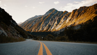 Mountain road cloudy sky sunset - a mountain in the background and a sky free wallpaper