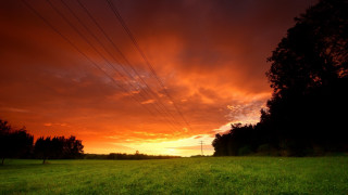 Sunset powerlines green field mountain - a green field below free wallpaper for desktop