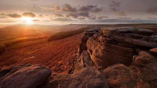 Sunset rocky cliff valley clouds - a sunset over a rocky cliff free wallpaper