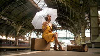 Woman sitting suitcase umbrella train - nearby free wallpaper