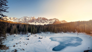 Snowy mountain lake forest sunset - a forest in the background free wallpaper