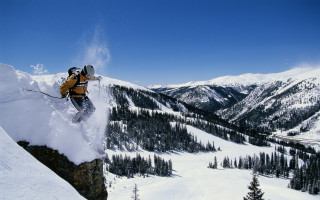 Man skier jumping cliff mountains - ski free wallpaper for desktop