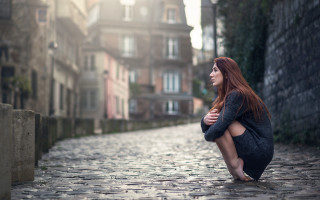 Woman cobblestone street cityscape redhaired - the background and a woman free wallpaper