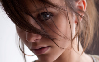 Woman serious tie portrait closeup - her face and hair free wallpaper