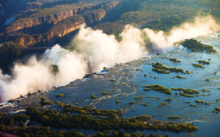 River steam bridge trees city - a bridge in the distance free wallpaper for desktop