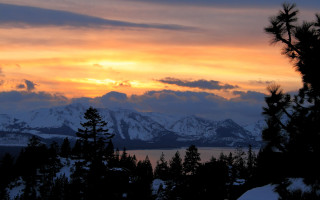 Sunset mountain range trees snow 2 - a sunset view of a mountain range free wallpaper