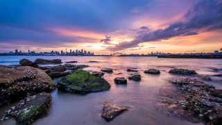 Sunset city water rocks dusk - rich moody colour free wallpaper