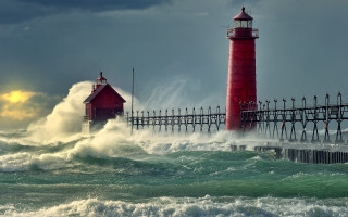 Lighthouse wave stormy beach sunset - a pier in the background free wallpaper