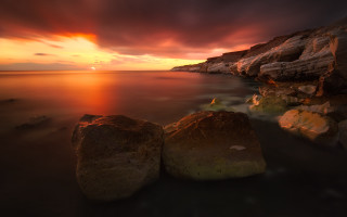 Sunset rocky beach mystical colors 2 - the foreground and a body of water free wallpaper