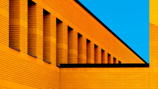 Yellow building clock blue sky 2 - a yellow building free wallpaper