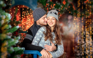 Christmas hug couple blurry bokeh - a blue chair free wallpaper
