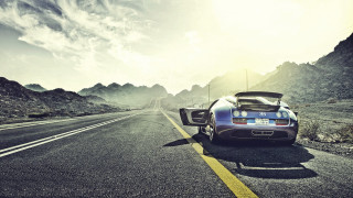 Mountain road sports car cinematic - a sports car free wallpaper