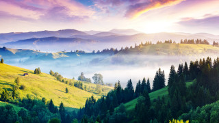 Mountain range foggy valley distant - a scenic view of a mountain range free wallpaper