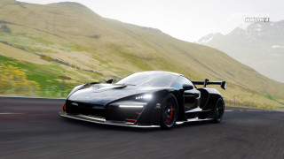 Black sports car mountain green - a green hillside in the background free wallpaper