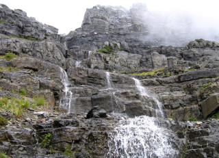 Waterfall rocks foggy sky person - a bunch of rocks free wallpaper