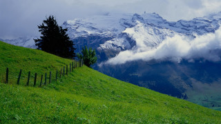 Grassy hill fence mountain clouds 2 - free landscape wallpaper