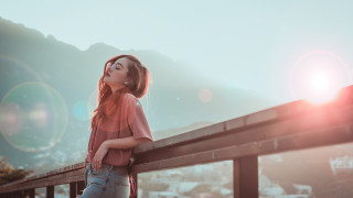 Woman leaning rail blowing hair - free vintage wallpaper