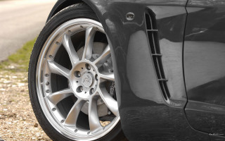 Car tire closeup roadside grass - rim free wallpaper