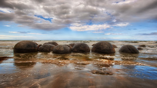 Rocks water beach clouds sky - a group of rocks free wallpaper