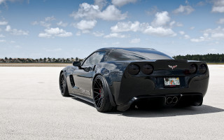 Black sports car concrete lot - a black sports car free wallpaper for desktop